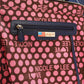 Close-up of Nicole Lee USA Color Block Handbag showing zipper and pink polka dot pattern with brand logo