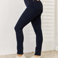 Judy Blue Garment Dyed Tummy Control Skinny Jeans in dark wash worn with white sneakers for a slimming silhouette.