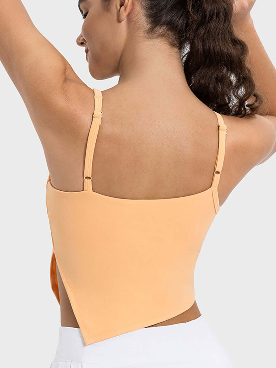 Back view of Millennia Slit Asymmetrical Neck Active Cami in orange showing stylish design and adjustable straps.