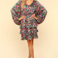 Woman wearing a colorful, floral V-neck layered dress with flowy sleeves, perfect for a feminine and charming look.