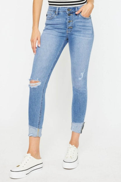 Distressed Cat's Whiskers Button Fly Jeans with a retro vibe, worn-in look, and casual style, paired with white sneakers.