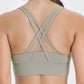 Back view of a stylish crisscross active tank in olive green, showcasing its trendy design and comfort.