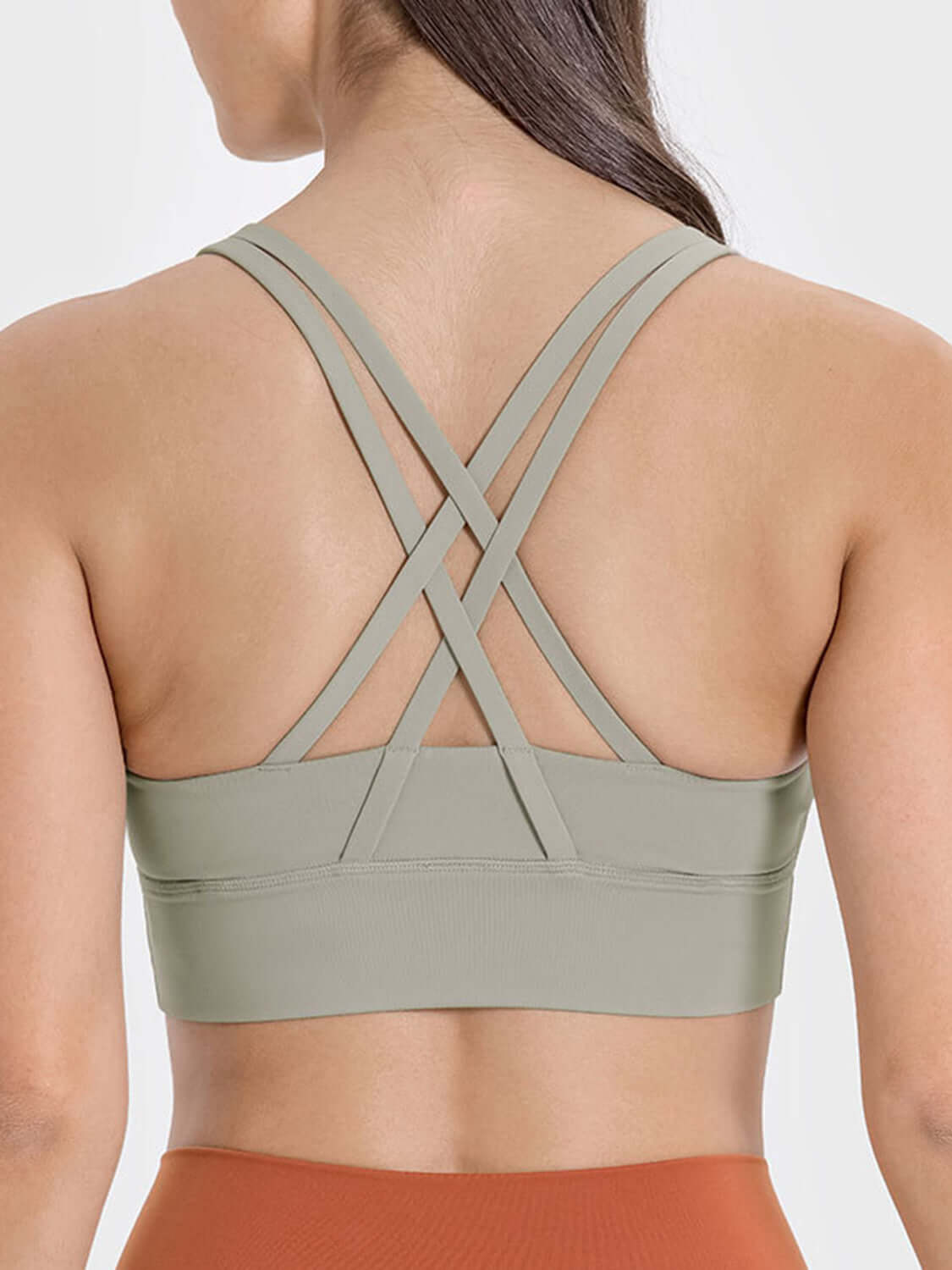 Back view of a stylish crisscross active tank in olive green, showcasing its trendy design and comfort.