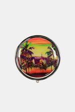 Nicole Lee USA Print Metallic Circular Large Pill Case with colorful tropical design and palm trees on a silver-tone metal exterior.