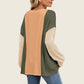 Stylish woman wearing Double Take Texture Contrast Round Neck Long Sleeve T-Shirt in trendy color combo, perfect for layering.