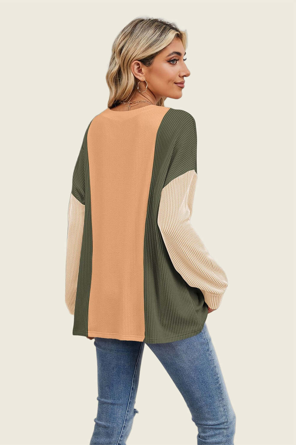 Stylish woman wearing Double Take Texture Contrast Round Neck Long Sleeve T-Shirt in trendy color combo, perfect for layering.