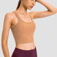 Sleek Millennia Racerback Sports Bra in tan, perfect for yoga and stylish workouts with removable padding.