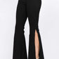 Black American Bazi Side Slit Flare Jeans with flattering flare legs and daring side slits, paired with nude heels for a stylish look.