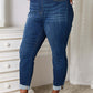 Woman wearing Judy Blue skinny cropped jeans with moderate stretch, styled with clear heels in a chic setting