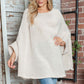 Woman wearing Bella Road Round Neck Batwing Sleeve Sweater, showcasing cozy and stylish batwing design in a soft, light color.