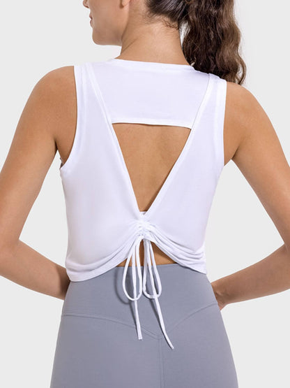 Back view of white Millennia Drawstring Cutout Active Tank showcasing unique cutout design and adjustable drawstring feature.