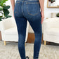 Model wearing Classic Handsand Skinny Judy Blue Jeans with hand-sanded finish and flattering fit, showcasing the back view.