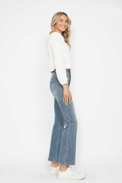 Woman in side profile wearing Judy Blue tummy control bootcut jeans with embroidered back pockets.