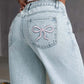 Back view of Bella Road Denim Bow Back Wide Leg Jeans showcasing playful bow detail on pockets.