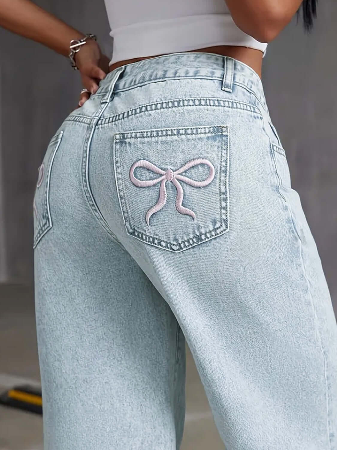 Back view of Bella Road Denim Bow Back Wide Leg Jeans showcasing playful bow detail on pockets.