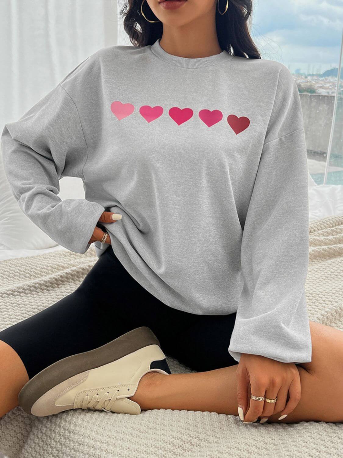 Devine Heart Dropped Shoulder Long Sleeve Sweatshirt with pink heart design, trendy and cozy for fashion lovers.