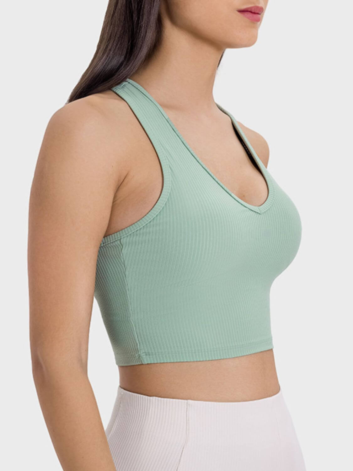 Side view of Millennia Scoop Neck Wide Strap Active Tank in mint green, highlighting its stylish design and support.