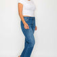 woman showcasing bytos Cat's Whiskers mid-rise ankle jeans with a stylish white t-shirt and trendy sandals.