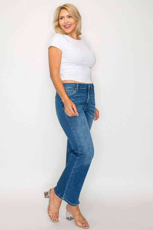 woman showcasing bytos Cat's Whiskers mid-rise ankle jeans with a stylish white t-shirt and trendy sandals.