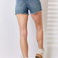 High Waist Raw Hem Denim Shorts by Judy Blue Jeans, back view showcasing raw hem detailing, paired with white top and boots.