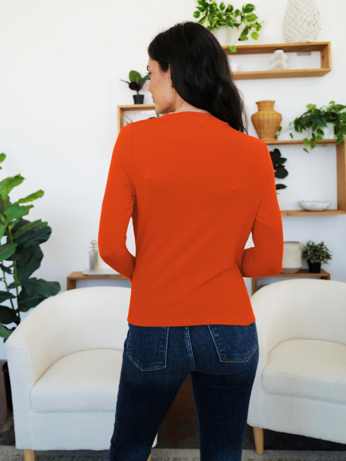 Woman wearing orange FAM-FAM Ruched Mock Neck Long Sleeve T-Shirt, perfect for fall styling and layering, shown from the back.