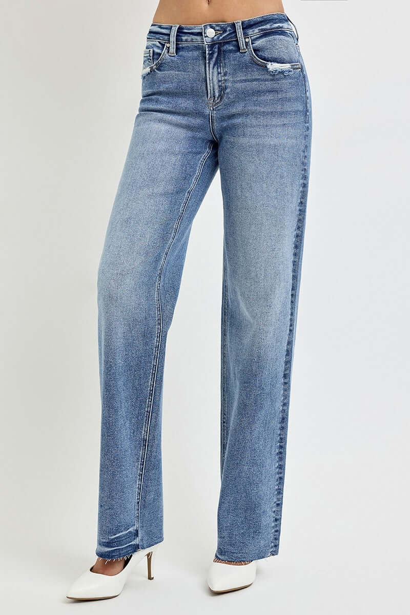 High rise straight leg jeans with pockets in blue, featuring a classic and stylish look, model wearing heels for a fashion-forward style.