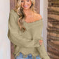 Woman wearing Bella Road frayed hem dropped shoulder sweater in cozy and stylish design, perfect for a casual chic look.