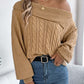 Woman wearing Bella Road Cable-Knit One Shoulder Long Sleeve Sweater in beige, paired with jeans for a cozy and stylish look.