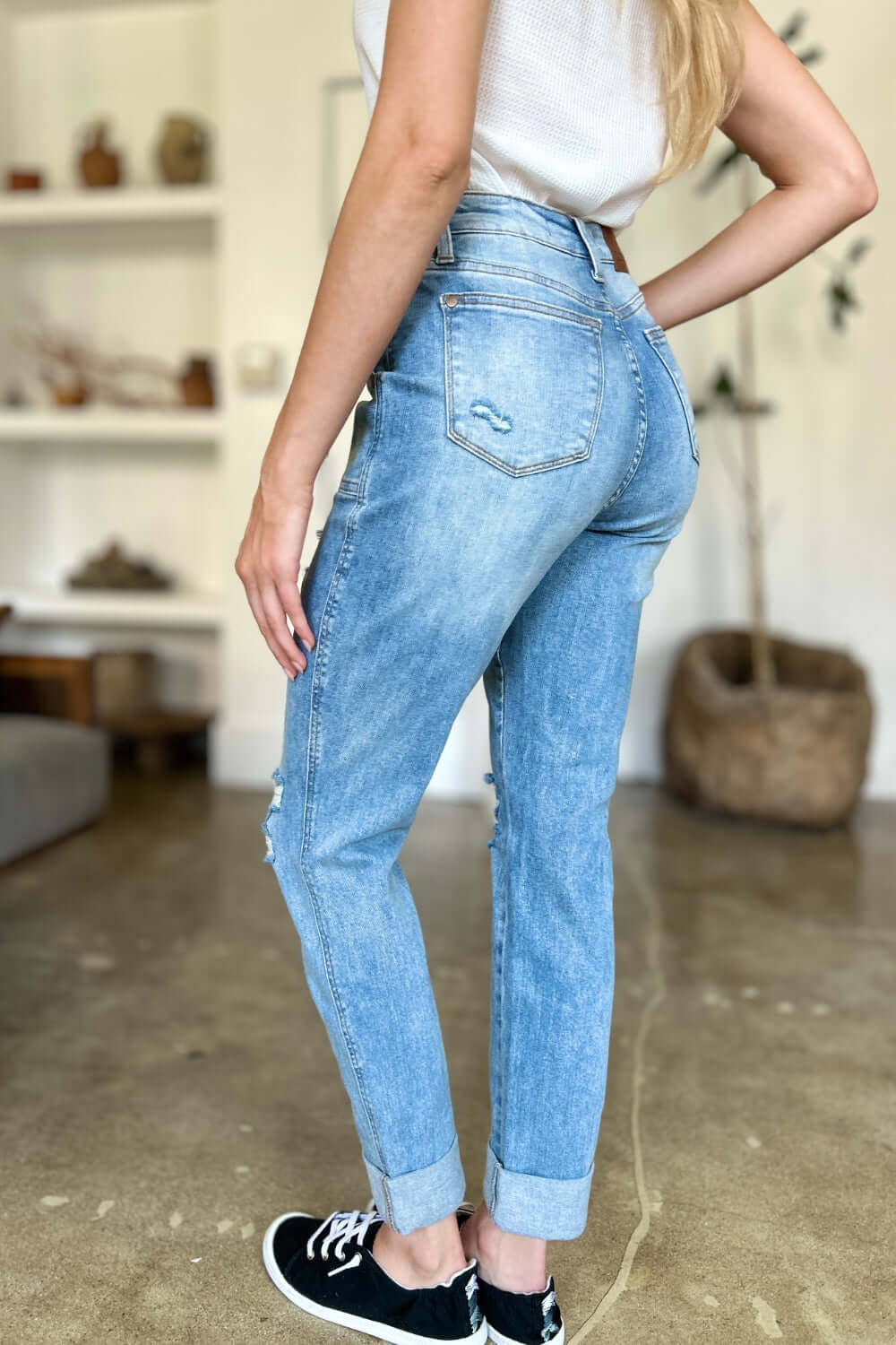 Woman wearing distressed straight Judy Blue Jeans with patch pockets, showcasing trendy casual-chic style and high-waist silhouette.