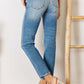 High Rise Distressed Slim Straight Jeans with a flattering silhouette, showcased from the back. Perfect blend of timeless style and edgy details.