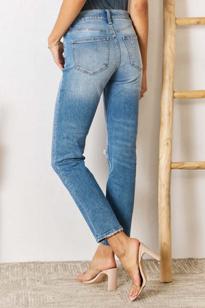 High Rise Distressed Slim Straight Jeans with a flattering silhouette, showcased from the back. Perfect blend of timeless style and edgy details.