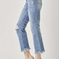 Woman wearing high waist distressed cropped bootcut jeans from Risen Jeans, paired with beige heels.