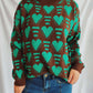 Woman wearing Bella Road Heart Contrast Long Sleeve Dropped Shoulder Sweater in brown and green hearts design.