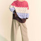 Stylish Davi & Dani wavy texture color block V-neck sweater in pink, cream, and lavender, paired with relaxed beige pants.