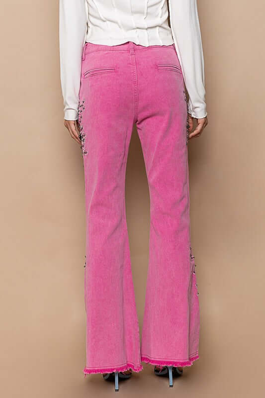 Back view of POL Raw Hem Embroidered Flare Pants in vibrant pink, featuring intricate embroidery and a trendy raw hem design.