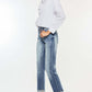 Woman wearing High Rise Cuffed Straight Jeans with white blouse and heels