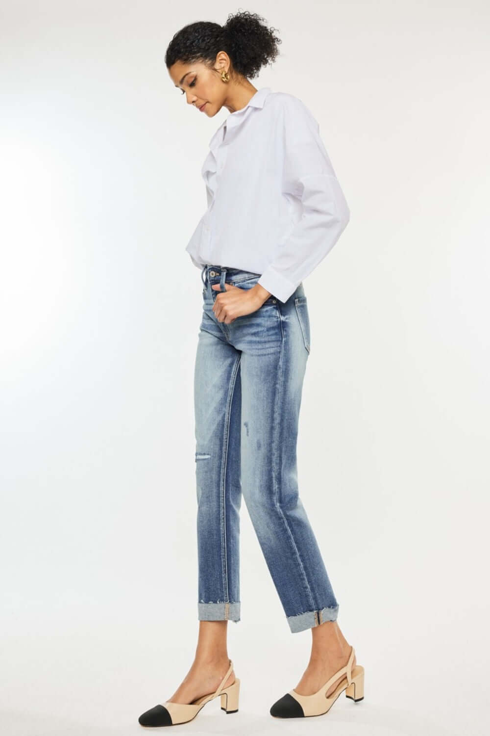 Woman wearing High Rise Cuffed Straight Jeans with white blouse and heels