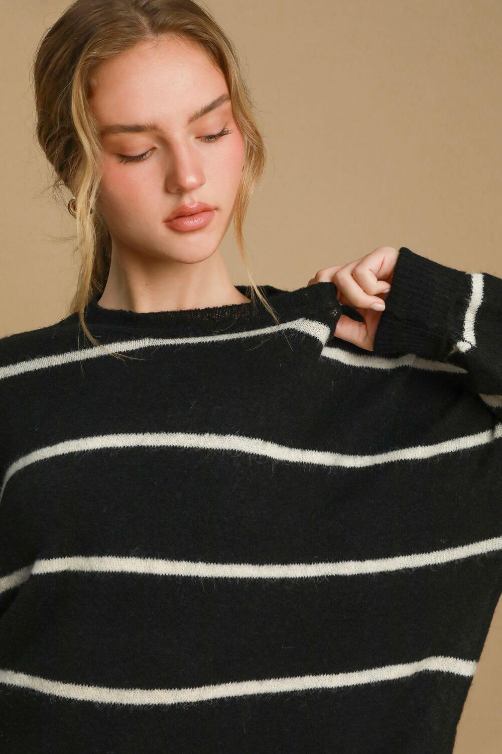 Model wearing the Umgee wool blend striped round neck sweater in black and white, perfect for cozy, stylish occasions.