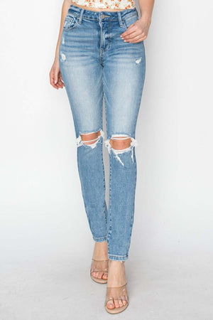 High Rise Knee Distressed Skinny Jeans with ripped knees by Risen Jeans, hugging curves perfectly in a trendy and edgy style.