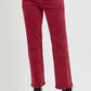 Burgundy high-rise straight jeans with patch pockets and black boots, showcasing a classic and slender leg look.