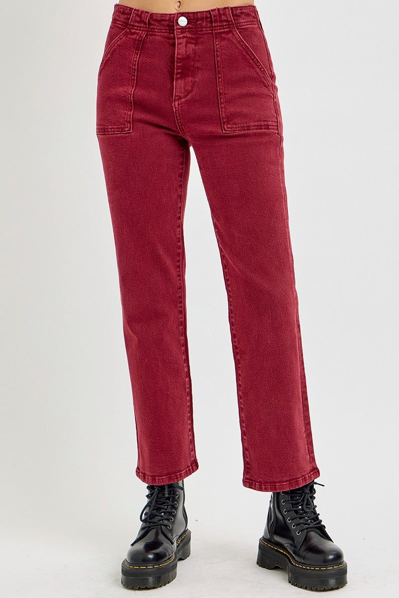 Burgundy high-rise straight jeans with patch pockets and black boots, showcasing a classic and slender leg look.