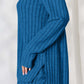 Woman wearing blue ribbed high-low top and wide leg pants set made of slightly stretchy polyester and elastane.