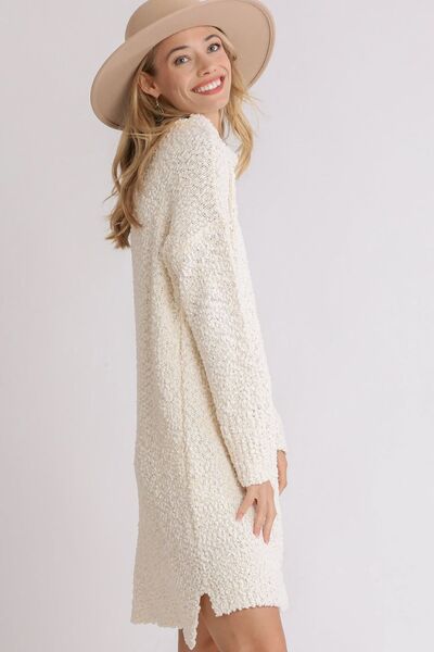 Model showcasing a stylish high-low boucle sweater dress in ivory, perfect for cozy chic looks.