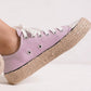 Stylish pink lace-up sneakers with woven espadrille sole, perfect for summer vibes and casual chic outfits.