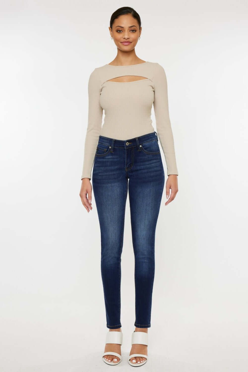 Stylish woman wearing Mid Rise Gradient Skinny Jeans with a flattering fit, perfect for a trendy and versatile look whether day or night.