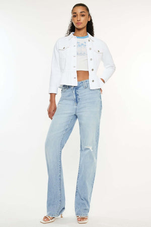 Woman wearing distressed high waist straight jeans with a white crop jacket and white heels for a trendy and comfortable look