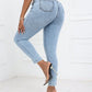 Woman wearing Bella Road high waist skinny jeans with pockets in light blue, showcasing back view and moderate stretch fabric, paired with high heels.