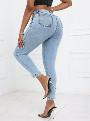 Woman wearing Bella Road high waist skinny jeans with pockets in light blue, showcasing back view and moderate stretch fabric, paired with high heels.