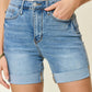 Tummy Control High Waist Denim Shorts by Judy Blue Jeans with pocket detailing, designed to shape and support the midsection for a flattering fit.