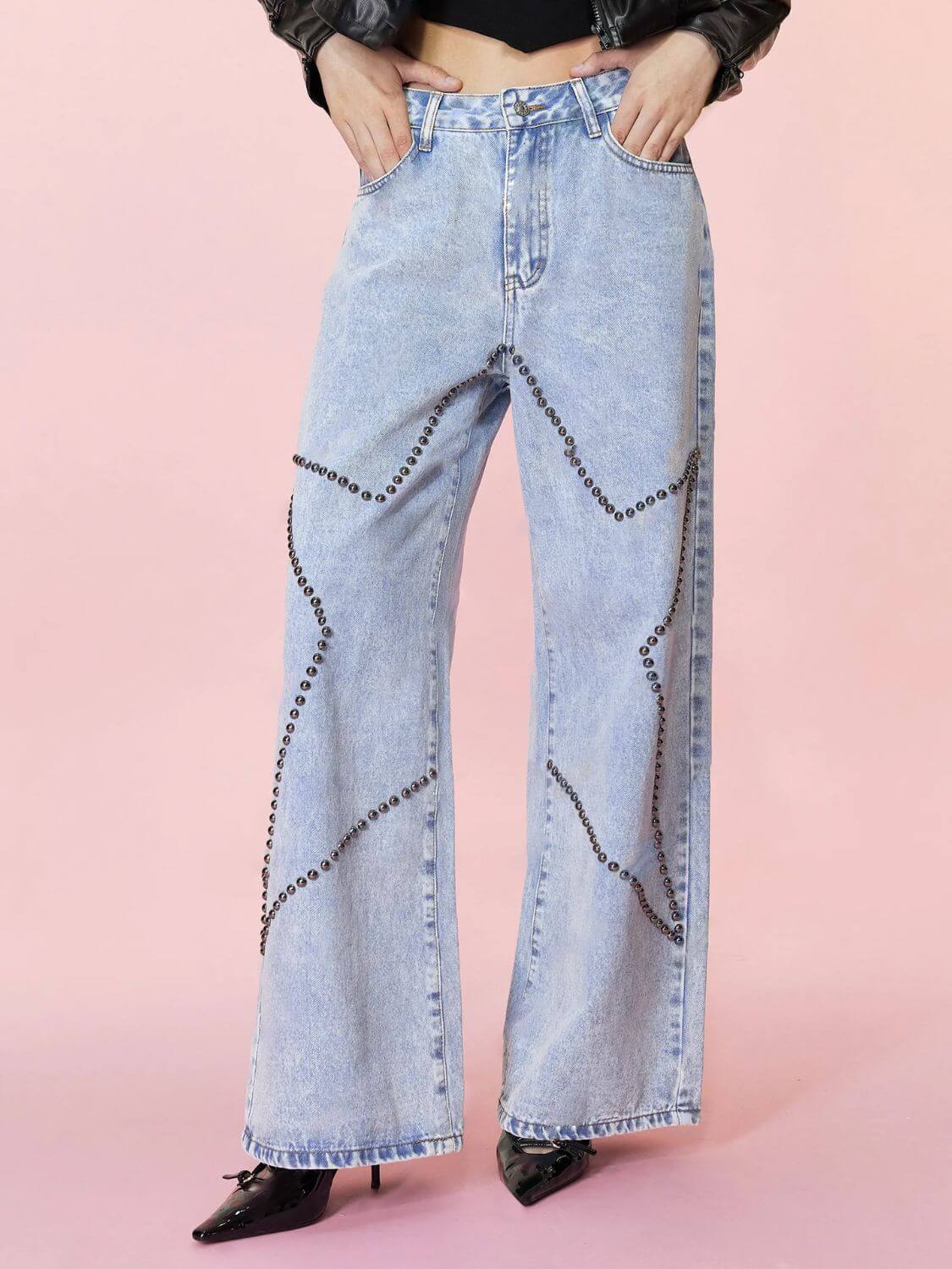 Trendy Bella Road Studded Star Straight Jeans with pockets, showcasing edgy style and functional design against a pink backdrop.